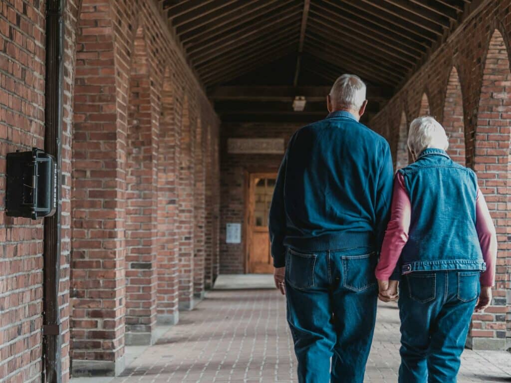 old couple walking while holding hands