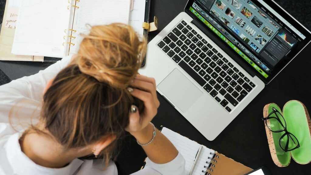 woman sitting in front of macbook
